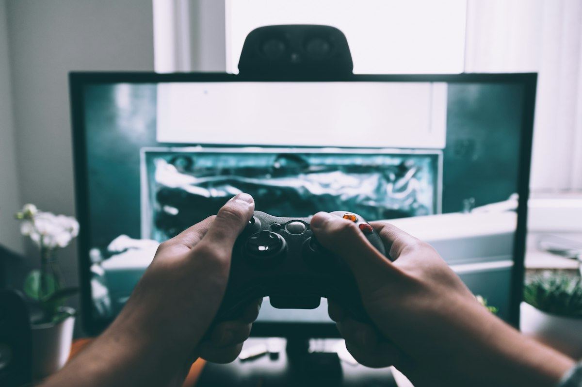 Two players holding controllers in front of a TV